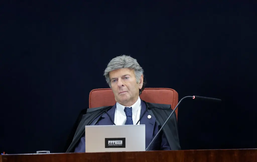 Supreme Federal Court Justice Luiz Fux seated at a desk with a laptop during a court session.