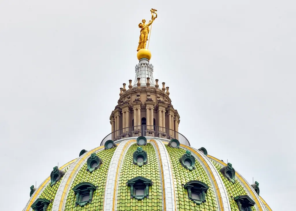 Close-up view of the green tiled dome and gold statue atop the Pennsylvania State Capitol