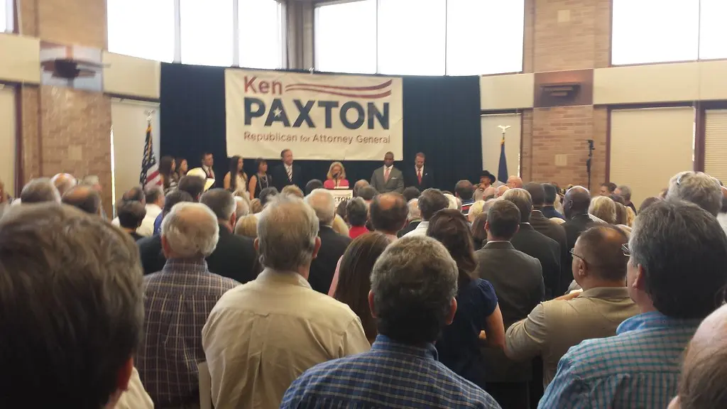 Ken Paxton standing behind a podium during his announcement run for Attorney General.